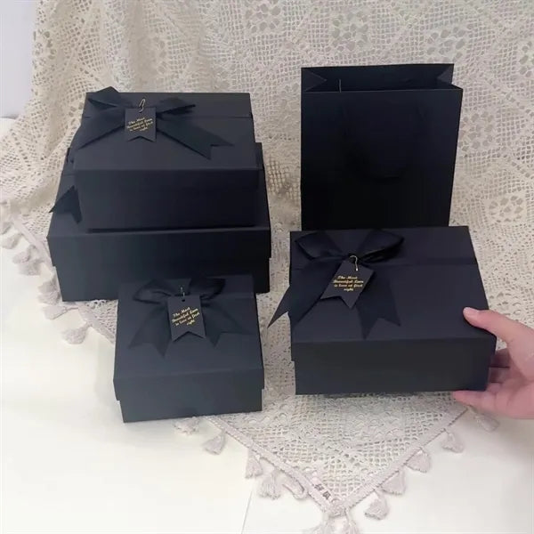 Black rectangular gift box with a bow decoration