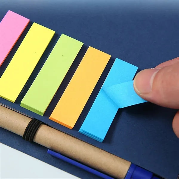 Brown paper notebook with pen and post-it notes