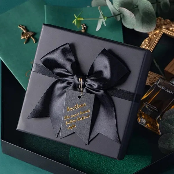Black rectangular gift box with a bow decoration